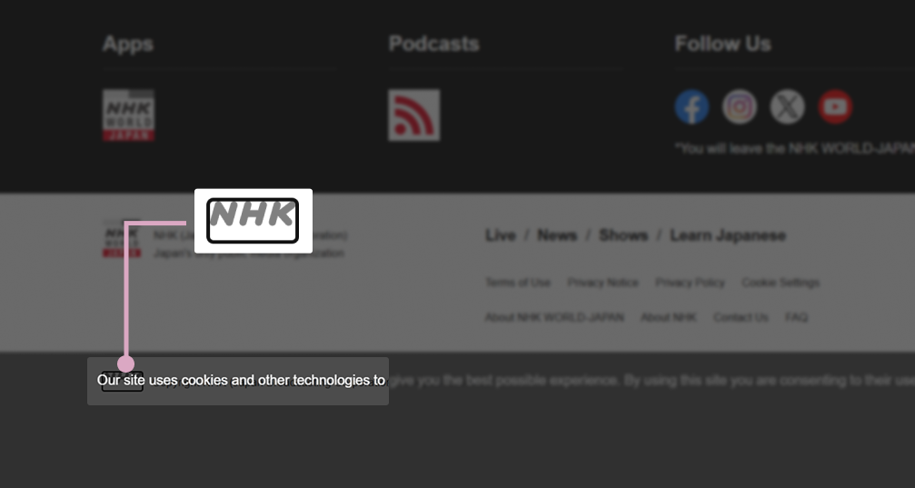 Part of the text “Our site uses…” from the semi-transparent banner obscures the “NHK” link. The link is outlined with a black border, and only the top part of the letters is visible. Nearby the same link is shown when it’s not obscured.